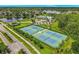 Aerial view of community tennis courts with lush landscaping and mature shade trees at 2054 Hammock Moss Dr, Orlando, FL 32820