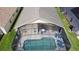 Aerial view of a screened-in pool with lounge chairs and outdoor seating, perfect for relaxation and entertaining at 2649 Hemingway Ave, Haines City, FL 33844