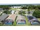 Aerial view of homes with screened-in pools backing onto a golf course with lush greenery in a vibrant community at 2649 Hemingway Ave, Haines City, FL 33844
