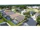 Aerial view of homes with screened-in pools backing onto a golf course with lush greenery in a vibrant community at 2649 Hemingway Ave, Haines City, FL 33844