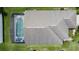 Aerial view of a home featuring a screened-in pool and patio area with a well-maintained roof at 2649 Hemingway Ave, Haines City, FL 33844