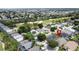 Displays a charming neighborhood with well-maintained homes, screened-in pools, and a community golf course at 2649 Hemingway Ave, Haines City, FL 33844