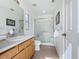 Clean bathroom with a glass-enclosed shower, a single sink vanity, and bright white walls at 2649 Hemingway Ave, Haines City, FL 33844