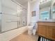 Neat bathroom featuring a shower-tub combo, a single sink vanity, and a well-lit mirror at 2649 Hemingway Ave, Haines City, FL 33844