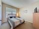 Cozy bedroom featuring a comfortable bed, a window for natural light, and a dresser for storage at 2649 Hemingway Ave, Haines City, FL 33844