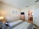Comfortable bedroom with a view of the ensuite bathroom and furnished with a TV and dresser at 2649 Hemingway Ave, Haines City, FL 33844