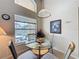 Bright dining nook showcases a glass table, four chairs, and view to the pool at 2649 Hemingway Ave, Haines City, FL 33844