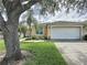 Charming single-story home with a well-manicured lawn and attached two-car garage at 2649 Hemingway Ave, Haines City, FL 33844