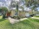 Charming single-story home with well-manicured lawn, a mature palm tree, and a two-car garage at 2649 Hemingway Ave, Haines City, FL 33844