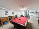 Open game room featuring a pool table, foosball table, and laundry area at 2649 Hemingway Ave, Haines City, FL 33844