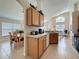 Kitchen view featuring wood cabinets, tile floor, and view to the dining room at 2649 Hemingway Ave, Haines City, FL 33844
