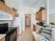 Functional kitchen offers wooden cabinets, black appliances, and tile flooring at 2649 Hemingway Ave, Haines City, FL 33844
