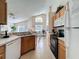 View of the kitchen featuring wooden cabinetry, tile floors, and modern appliances at 2649 Hemingway Ave, Haines City, FL 33844