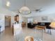 View of an open floorplan showcases the living room, dining area, and kitchen at 2649 Hemingway Ave, Haines City, FL 33844
