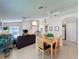 Open-concept living room, featuring a dining area, vaulted ceilings, and neutral flooring at 2649 Hemingway Ave, Haines City, FL 33844