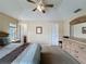 Bright main bedroom featuring a ceiling fan, neutral walls, carpet, and ensuite bathroom access at 2649 Hemingway Ave, Haines City, FL 33844