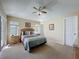 Bedroom featuring a queen-size bed, ceiling fan, side tables with lamps, and windows at 2649 Hemingway Ave, Haines City, FL 33844