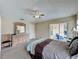 Well-lit main bedroom with a ceiling fan, neutral walls, a dresser, and access to the outdoor patio at 2649 Hemingway Ave, Haines City, FL 33844