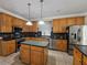 Traditional kitchen with wood cabinetry, an island, and stainless steel appliances at 2735 Scarborough Dr, Kissimmee, FL 34744