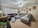 Inviting living room with large sectional sofa, ceiling fan, and plenty of natural light at 2735 Scarborough Dr, Kissimmee, FL 34744