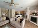 Open-concept living room with a fireplace, tile flooring, and views of the kitchen and foyer at 2735 Scarborough Dr, Kissimmee, FL 34744