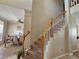 View of the carpeted staircase with views to the dining room at 2735 Scarborough Dr, Kissimmee, FL 34744