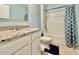 Well-lit bathroom featuring a modern vanity, sink, and a shower-tub combination with stylish curtain at 2839 Harmonia Hammock Rd, Harmony, FL 34773