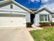 Inviting front view of the home featuring a garage, well-maintained lawn, and appealing design at 2839 Harmonia Hammock Rd, Harmony, FL 34773