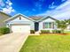 Charming single-Gathering home with a well-manicured lawn and inviting curb appeal under a beautiful sky at 2839 Harmonia Hammock Rd, Harmony, FL 34773