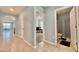 Open hallway with tile floors connecting to a bathroom and bedrooms with neutral interior at 2839 Harmonia Hammock Rd, Harmony, FL 34773