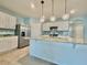 Modern kitchen featuring white cabinets, stainless appliances, and a central island at 2839 Harmonia Hammock Rd, Harmony, FL 34773