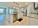 Open-concept kitchen with island seating and stainless steel appliances at 2839 Harmonia Hammock Rd, Harmony, FL 34773