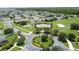 Aerial view showcases the neighborhood, community pool, and playground in lush landscaping at 2924 White Cedar Cir, Kissimmee, FL 34741