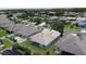 Wide aerial perspective of the home, showcasing its well-kept lawn and serene community setting at 2924 White Cedar Cir, Kissimmee, FL 34741
