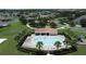 Aerial view of community pool and clubhouse surrounded by lush landscaping and palm trees at 2924 White Cedar Cir, Kissimmee, FL 34741