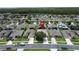 Overhead shot of a residential area showcasing homes with solar panels and neatly kept yards at 2924 White Cedar Cir, Kissimmee, FL 34741