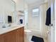 Cozy bathroom with a vanity sink and a shower-tub with curtain and shelf at 2924 White Cedar Cir, Kissimmee, FL 34741