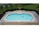 Aerial view of community pool with a brick paver surround and many lounge chairs for relaxation at 2924 White Cedar Cir, Kissimmee, FL 34741