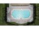 Aerial top-down view of people swimming in the community pool surrounded by lounge chairs at 2924 White Cedar Cir, Kissimmee, FL 34741