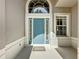 A close-up of the inviting blue front door with decorative windows and trim at 2924 White Cedar Cir, Kissimmee, FL 34741