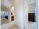Hallway view showcases access to the bathroom and bedroom areas with carpet and tile flooring at 2924 White Cedar Cir, Kissimmee, FL 34741