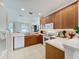 Kitchen with wooden cabinets, white countertops, tile flooring, and modern appliances at 2924 White Cedar Cir, Kissimmee, FL 34741