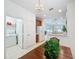 A kitchen with wood table and view of the laundry room with white appliances at 2924 White Cedar Cir, Kissimmee, FL 34741