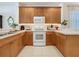 Bright kitchen featuring wooden cabinets, modern appliances, and neutral countertops at 2924 White Cedar Cir, Kissimmee, FL 34741