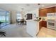 Open kitchen design featuring modern appliances and a dining area with natural light at 2924 White Cedar Cir, Kissimmee, FL 34741
