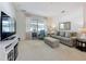 Inviting living room featuring a cozy sofa, ottoman, and modern furnishings at 2924 White Cedar Cir, Kissimmee, FL 34741