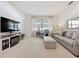 Bright and airy living room with carpet, neutral furniture, and a modern fireplace at 2924 White Cedar Cir, Kissimmee, FL 34741