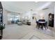 Bright living room featuring carpet, a large window, and an adjacent dining area at 2924 White Cedar Cir, Kissimmee, FL 34741