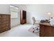 Home office featuring a large window, wooden furniture, and light-colored carpet at 2924 White Cedar Cir, Kissimmee, FL 34741