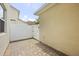 An outdoor patio features brick pavers and a white fence in the backyard at 2966 Aqua Virgo Loop # 16, Orlando, FL 32837